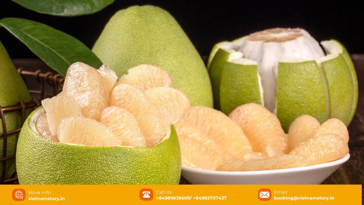 A Guide to the Wonderful World of Fruits in Vietnam for Travelers 2025 7 Large green Pomelo fruit, partially peeled to show thick white pith and pale yellow flesh segments.